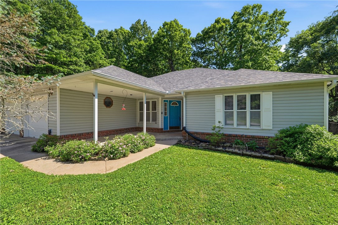 Escape to your own private retreat on 7 beautiful rural acres with this secluded 4-bed/2-bath, one-level home. 2289 sq ft (or 2667 total sq footage counting the heated/cooled sunroom. Some appraisers count it and some do not.) This property combines comfort, space and peaceful country living. Recent updates have included new LVP flooring throughout, new fencing, and some rooms have been freshly painted. The kitchen is great for cooks as it has 2 ovens! New roof and gutters in 2024. This property features a 30x40 sq ft detached garage/workshop with a window air unit. Also on the property is a 40' RV cover. Relax, unwind, and enjoy the privacy and beauty this unique property has to offer. Ozark Go internet.