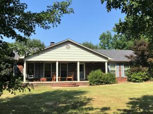 100% financing available. 13.77 acres of wildlife and room to explore. Spring-fed pond and rockin' chair worthy front porch and back deck perfect for grilling and sunsets. Sun-room for office space. Rock wood-burning fireplace, spacious rooms and closets. Shop fit for a craftsman with bay door, front and rear entry doors and own electric meter. Additional 2 metal carports included to accommodate up to 8 covered parking spots total.