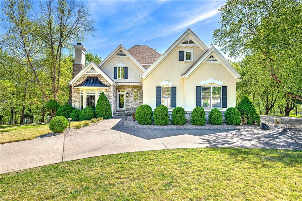 Set on a premier lakefront lot along the shores of Table Rock Lake, this exceptional residence offers a private, park-like retreat where refined living meets natural beauty. From the moment you arrive, striking curb appeal sets an elegant tone. Designed for relaxation and entertaining, the home features tiered patios cascading to the water’s edge and a tranquil private waterfall, creating a resort-style ambiance. Inspired by a Better Homes & Gardens floor plan, the home has been meticulously renovated with designer finishes throughout. The open-concept main level is filled with natural light, showcasing expansive windows, rich wood ceilings, and curated details. The luxurious primary suite offers a sitting area and a spa-like travertine shower. Upstairs includes two bedrooms with a Jack-and-Jill bath and lounge, while the lower level features an ensuite bedroom, den, fitness room, and half bath, plus premium upgrades throughout. The home was completely renovated in 2013, from top to bottom.