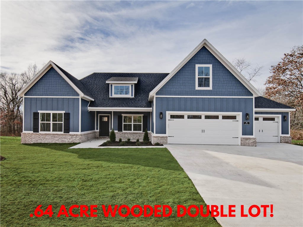 Check out this stunning new construction home on a .64 acre double wooded lot! Plenty of room for a shop or RV pad! Easy access to Highlands Golf Course, Lake Loch Lomond Boat Launch, and I-49! WOOD FLOORS THROUGHOUT! (NO CARPET) 3 car oversized garage! With 4 bedrooms and a bonus room complete with a full bath, there's plenty of space for everyone. The vaulted living room features beautiful beams and elegant wood floors, adding to the home's charm. The kitchen showcases custom cabinets, a gas range, and 3 cm quartz countertops throughout. Retreat to the primary bath, which offers a luxurious large walk-in tile shower, a free-standing tub, and generous closet space. Huge covered back patio! This home perfectly balances tranquility and accessibility. Plus, take advantage of $3,500 in buyers closing costs, courtesy of the builder's preferred lender!