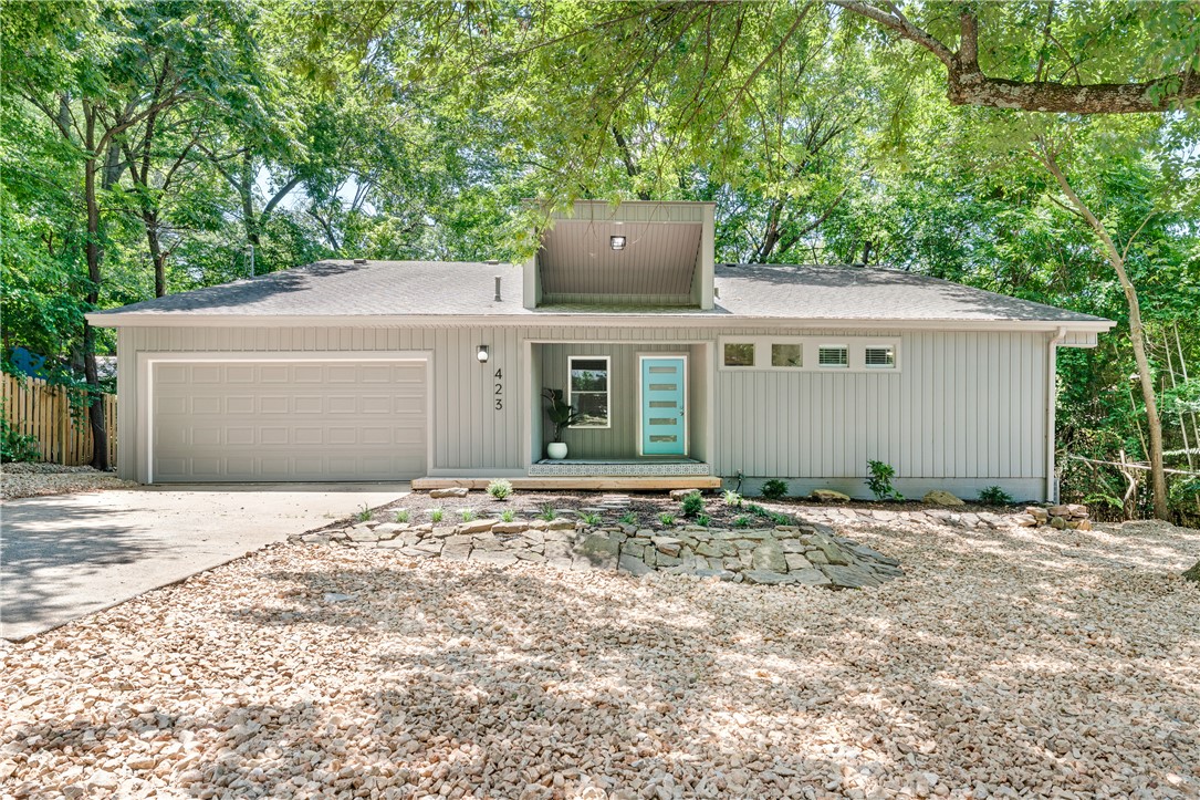 Perfectly positioned in the heart of Fayetteville, this beautifully remodeled 3 bed 3 bath home offers the best of city living just minutes from the University of Arkansas, Wilson Park, Dickson Street and downtown, while an expansive deck surrounded by mature trees provides a peaceful retreat to enjoy nature. Gather with family and friends in the open living area that flows effortlessly into the dining space and kitchen, while a versatile bonus room offers endless possibilities as a home office, fitness space, or creative studio. Wake up in the primary suite and step directly onto the deck to enjoy peaceful views and fresh morning air. The sunroom provides a bright, relaxing space to read or simply take in the scenery before leading out to the spacious deck for even more room to unwind. Two additional bedrooms and full baths provide comfortable accommodations for family, guests or multigenerational living. Conveniently located near shopping, dining, parks and schools, this home offers comfort and convenience.
