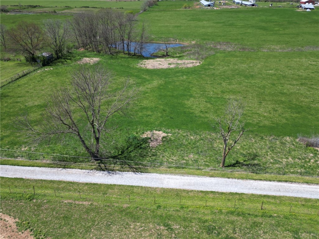 Discover the perfect blend of tranquility and convenience on this 5-acre parcel of land, featuring a level, open terrain that is ideal for building your dream home. The property boasts a charming pond, adding a touch of serenity and natural beauty to the landscape. With Rural water available at the road, utilities are easily accessible, making it convenient for future development. Situated in a prime location between Gentry and Siloam Springs, this property offers the best of both worlds-a peaceful retreat within reach of amenities and services.  Don't miss this opportunity to create your own slice of paradise in this desirable and well-located piece of land.