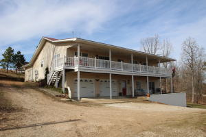 Custom home in the country with spectacular views. This home features mother-in-law suite, man cave and great room with views from the large decks and patio.  Master suite with door to the deck, walk in closet, jetted tub and shower.  Large 40x40 shop with drive thru door and low maintenance home with metal roof. Home has 3 bed and 2.5 ba with apartment having 2 bed 1 ba. Sitting on 1.6 acres, less than 8 miles to town and on paved hwy.