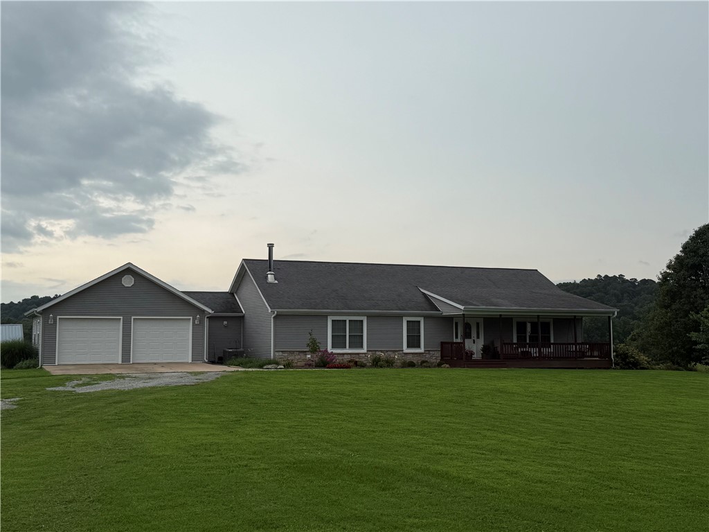 We've long admired this beautiful spot and are thrilled to present a unique farm located on the western side of Benton County. Picture yourself on approximately 28 acres, just north of Spavinaw Creek and off Hwy 43. The charming home welcomes you right from the road, featuring a lovely front porch that leads directly into a cozy living room and an inviting open kitchen. Enjoy a cup of coffee on the back deck or make your way to the lower level, where you can find additional living space with a fireplace, bedrooms, and room for games. There is also a fantastic shop space perfect for running your small business. And for the livestock enthusiasts, woodworkers, or DIY aficionados this place has everything you need to bring your dreams to life. Sellers are motivated and would love to close by fall 2026. Come explore the possibilities; you wont regret it!