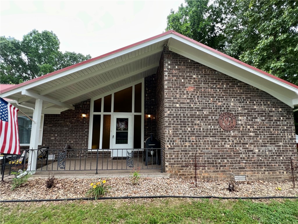 Looking for that country feel with large trees and a .85 acre lot but only be about 10 minutes from downtown Rogers?! Look no further! 53 Alton Cir is it! This updated home is in is in a quiet, established neighborhood.  Enjoy peaceful nights in your sunroom in your private backyard among the tall trees.  Or soak in the hot tub in your screened in patio. The kitchen offers loads of counter space and cabinetry and  with an eat in kitchen area and a family room with cozy corner fireplace in the open space, it makes it great for family gatherings or entertaining.  Metal roof and iron fencing are low maintenance and easy to maintain So much to offer!