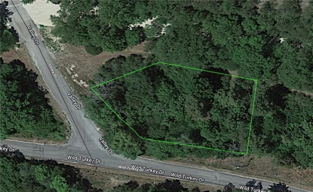 This corner lot backs up to Haddock Creek. A wet weather creek just outside your backyard. It's a wooded .39 acre lot (+/-) with utilities (water, sewer, and electricity) at the road, minutes from all that Holiday Island has to offer. Plenty of hardwoods on a lot that is 94x94x128x97x136 (think crayon shaped), giving you room for additional structures. Amenities are close and include the marina, fishing dock, rec center, swimming pool, tennis courts, and 2 golf courses, plus shopping, banking, and restaurants. The bonus is Eureka Springs, which is just a few minutes down the road! Motivated sellers - come take a look!