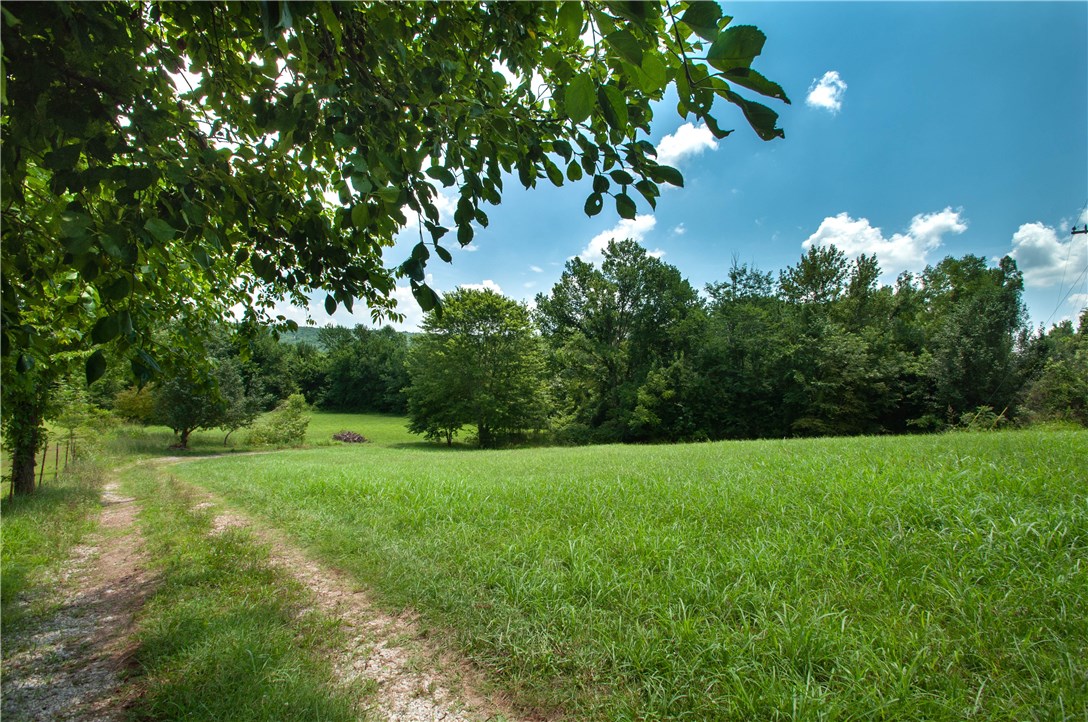 Attention deal hunters!  This super-solid 2,140 ft. brick home and 25+ acres just South of town in the city limits of West Fork is PRICED TO SELL.  This spacious 3 bed 3 bath home needs very little TLC and some updating to be your country oasis.  Your land goes all the way from McKnight to the West Fork of the White River with hundreds of feet of frontage.  Suitable for farming or just our own little hunting/outdoors paradise.  Privacy all around you.  Due to estate requirements, likely cannot be split, but at this price, you can afford it all.  All offer will be considered.