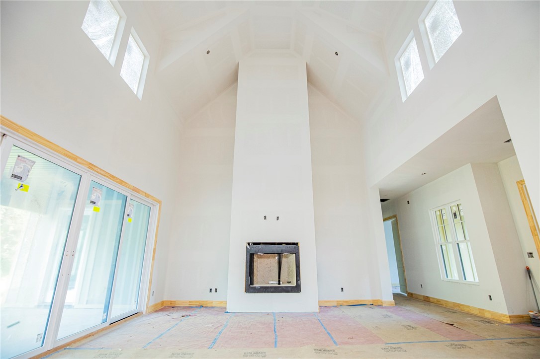 Soaring ceilings, ample windows, and a large lot make this light filled home a downtowner's dream.  Bike to the farmer's market and prepare gourmet meals in your open kitchen, enjoy company in the spacious living room, or retreat to the patio out the massive French sliding glass doors to catch a sunset in front of the outdoor fireplace.  Don't miss the craftsmanship of the custom cabinets, the wood floors, the vaulted ceilings, or the designer color scheme.  This home really does have it all--4 bedrooms and 3 baths all on the main level, plus a mud room and office nook.  Upstairs you will find a landing and a bonus room full of possibilities. Great location where you can easily enjoy the best restaurants, nightlife, and local shopping. If nature is your thing hit the mountain bike trails or stroll to the park with your furry friends.  Then clean them up in the built in dog shower.  Just minutes from the trail system. Crystal Bridges, several neighborhood schools, and the dog Park!