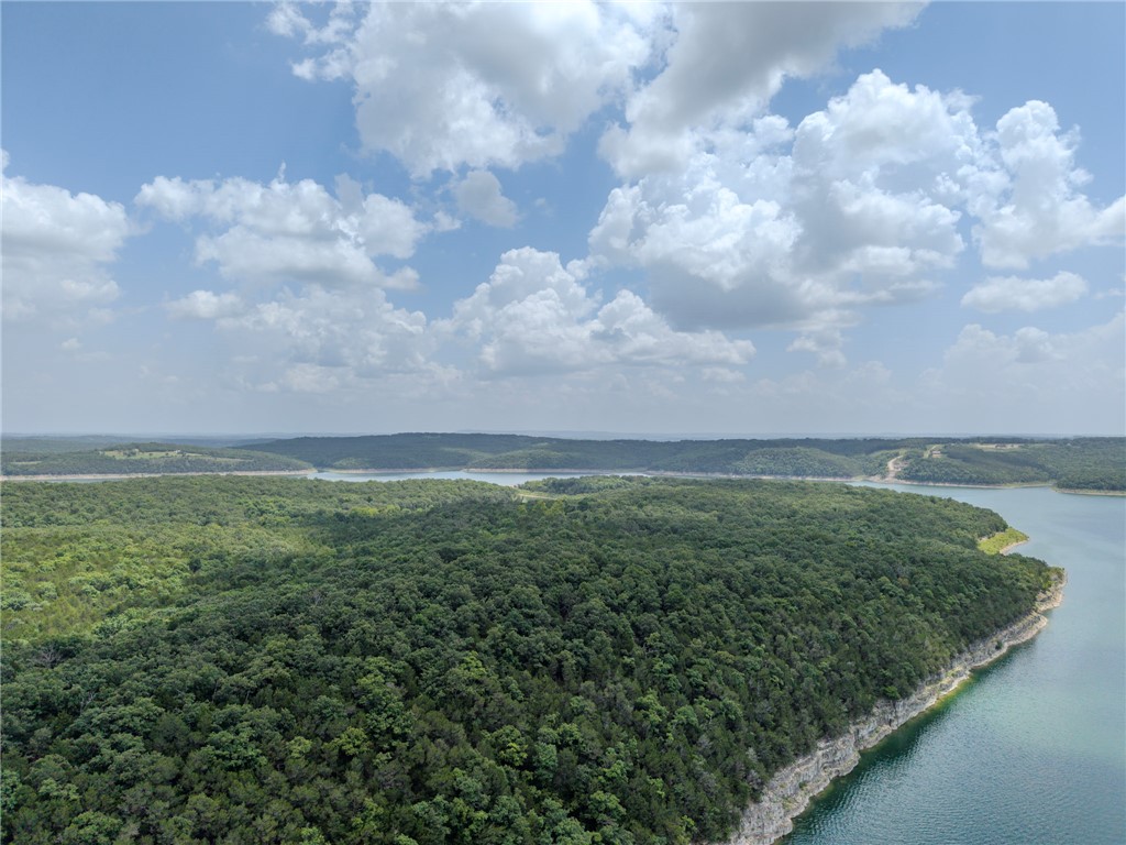 Spanning 112 acres (m/l) along the shores of Bull Shoals Lake, this exceptional tract is the last remaining large-acreage parcel in one of Boone County’s premier lakeside communities. Featuring direct access to a private, secluded cove and sweeping Ozark panorama views, the property offers a rare canvas for your vision—whether that’s a luxury private estate, an exclusive hunting retreat, or a cherished family legacy compound. The rolling Ozark topography provides several ideal home sites surrounded by thriving local wildlife and complete natural privacy. With protective covenants in place to preserve your investment and world-class boating and fishing right in your backyard, this property seamlessly pairs peaceful seclusion with effortless accessibility.
