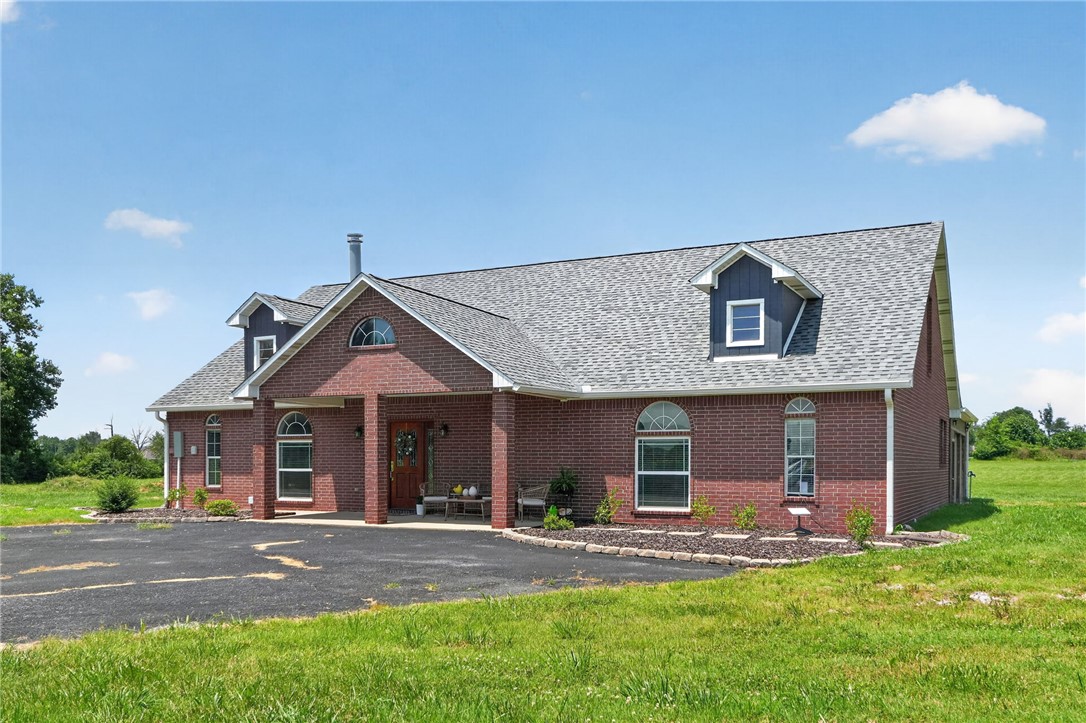 Situated on a 4-acre corner lot, this all-brick 3-bedroom, 2-bath home delivers country living just minutes from Siloam Springs and HWY 412. Four acres leave room for cattle, hay, garden, a motorcycle track. The 2006-built home spans 3,000+ sqft, featuring a 517 sq ft upstairs bonus room with cathedral ceiling (media room or man cave), easy-access plywood-floored walk-in attic storage, and walk-in closets. Granite counters, a 2026 Smart Bosch dishwasher (5-year warranty), LG Smart Gas Convection Range (2021), and upgraded range hood anchor the kitchen. A 2022 High Efficiency Blaze King 40" wood stove anchors the living area. Solid wood doors, Delta faucets (lifetime warranty), oil-based repaint, and insulated garage door with opener complete the finishes. Major updates: 2025 roof, 2025 meter loop and buried electrical line, and a new well pressure tank. Double-pane vinyl windows, LED lighting, Energy Star appliances. 3 covered patios. Siloam Springs Schools. No POA. Also listed with full 8.96 acres — ML # 1355664.