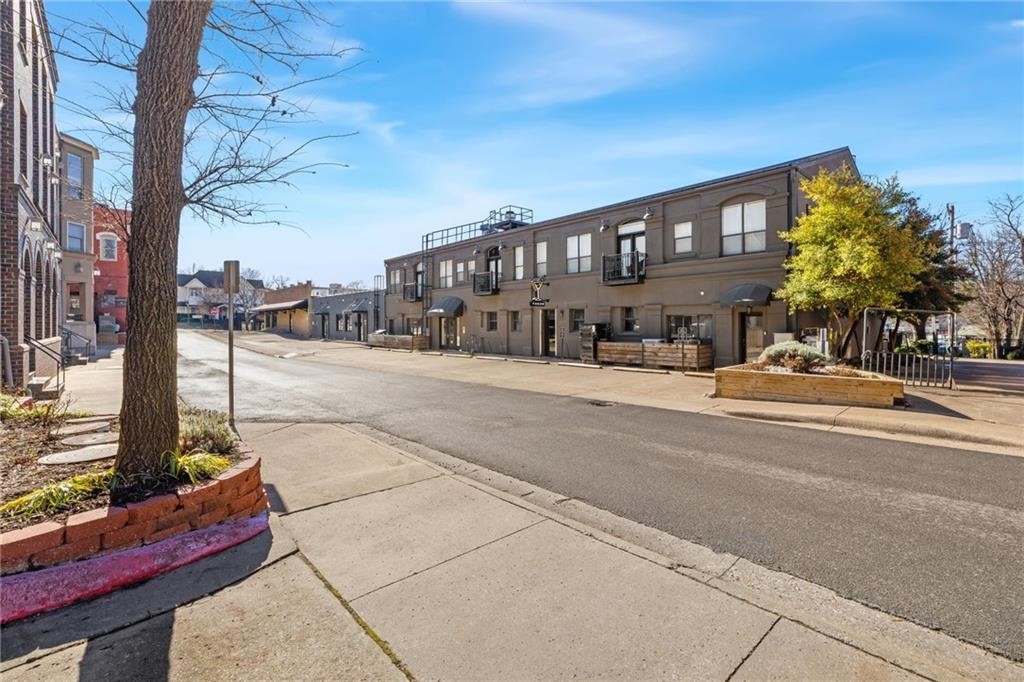 Adorable condo located in Downtown Fayetteville’s Art District with remarkable VIEWS.  Steps away to ALL of the fun, fine dining, arts, and entertainment!  596 heated sq ft offers 1 bedroom, 1 full bathroom, eat in kitchen, living room, and laundry.   Amenities include wood floors, tall ceilings, washer, dryer, refrigerator, Juliet balcony overlooking Theo’s patio, and 1 reserved parking spot.  Property to be sold FULLY FURNISHED!  Move in and start calling the HOGS in perfect time for baseball season!