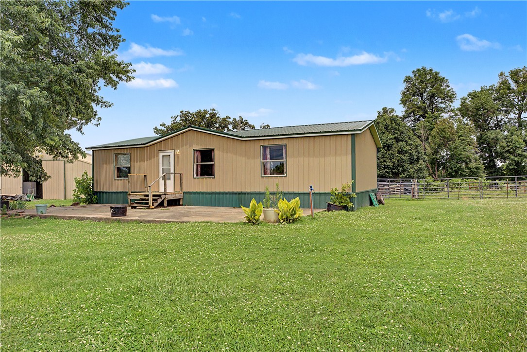Welcome home to country living! Want peaceful acreage close to town, search no further. 
The land yields 8.54 acres of pastureland with mature trees and a large pond. Wire fencing surrounds the whole property and currently holds livestock. 
The double-wide modular home features a 5 year old metal roof and metal siding, as well as a 6 year old A/C unit. The 30x40x12 metal shop is a worker’s paradise. A well shed provides extra water for crops and livestock, while the home is on public water. 
10 minutes from Gravette, AR and 0.7 miles from a paved road provides a convenient lifestyle while having access to the quiet countryside. Come view this desired location before it’s too late!