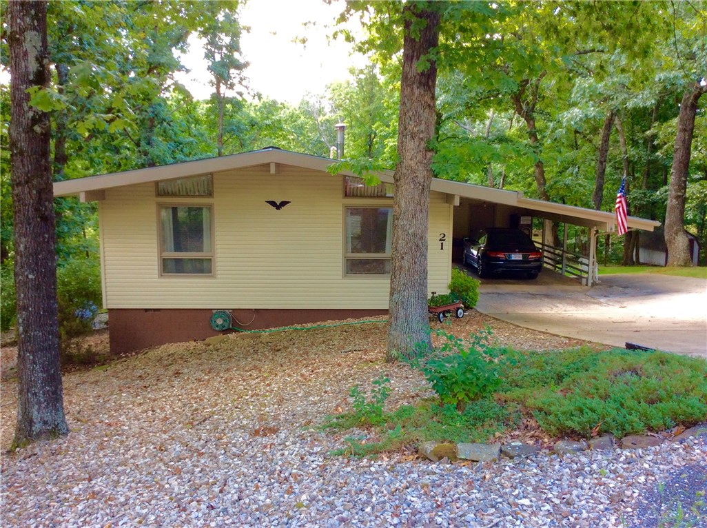 Charming home that is move in ready.  Owners have put on vinyl siding, replaced original septic tank, put on new roof including decking in 02, Corian countertops in kitchen and installed a gas log stove in Living room.  This home features 2 bedrooms and 1 1/2 baths.   Refrigerator, washer/dryer & freezer convey with property.  There is additional storage under carport and in crawl space plus a 12'x8' detached storage building in back yard.  1 car carport plus concrete parking pad beside carport.  Large cul-de-sac backyard with common ground ravine behind yard.  Quiet neighborhood.   500 gallon propane tank is owned by seller and is 95% full.  Buyer to pay going rate for the propane.  Ramp from carport goes to back deck and through patio doors if wheelchair access is needed.  Property is being "Sold As IS".   A home warranty covering all appliances, electrical, plumbing, heating & air will be provided to buyer by seller.