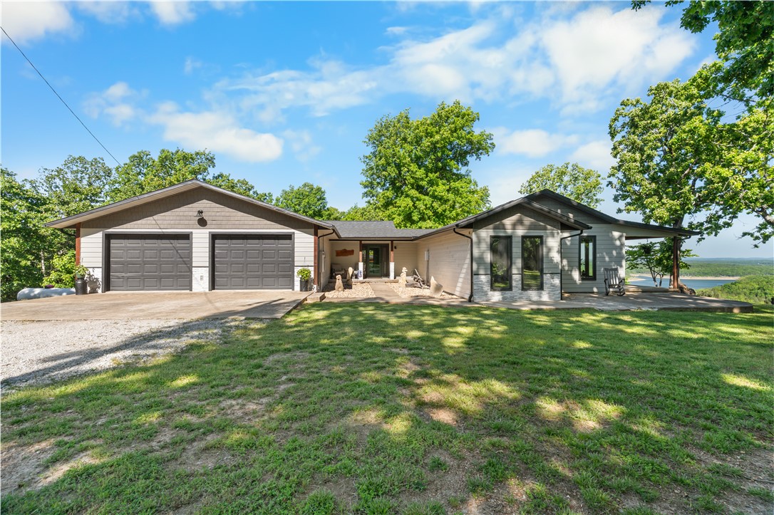 Experience the best of Bull Shoals Lake living with this lakefront property offering direct access and sweeping panoramic views. This spacious 3-bedroom, 3-bath home includes two bonus rooms, ideal for guests, hobbies, or workspace, along with a storm shelter for peace of mind. Thoughtful updates throughout include new windows, doors, flooring, and a beautifully added kitchen and coffee bar. Step outside onto the new Trex deck and take in the serene surroundings. The property is equipped with fiber optic internet, a private well, and modern mechanical systems, including HVAC and generator. A detached shop with wood stove and a 4x4 path to the lake enhance both usability and recreation. Conveniently located near Peel Ferry and local marina, this is a perfect setting for enjoying the natural beauty of the Ozarks.