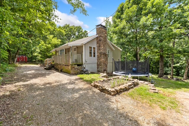 Tastefully Remodeled 3BR/2BA home on 30 +/- wooded Acres in a convenient NWA location. This home is located just minutes from Prairie Grove, the Hwy 62 Bypass, & I-49, providing easy access throughout the region. Extensive renovations incl new electrical, plumbing, sheetrock, roof, septic system, hot water heater, windows, flooring, & more. Interior features incl wood-plank flooring, granite countertops, & updated kitchen & bath finishes. The basement provides a large storage area & an additional flex room that can be used as an office, hobby space, workout room, or add'l living area. The property offers mature timber, scenic natural benches, rolling terrain, & abundant wildlife, creating an ideal setting for outdoor enthusiasts, hunting, hiking, or exploring. Enjoy peaceful views from the back deck overlooking the property. Two storage buildings provide add'l space for equipment & tools. A rare opportunity to own a move-in-ready home w/privacy, acreage, & convenient access to town & major transportation routes.