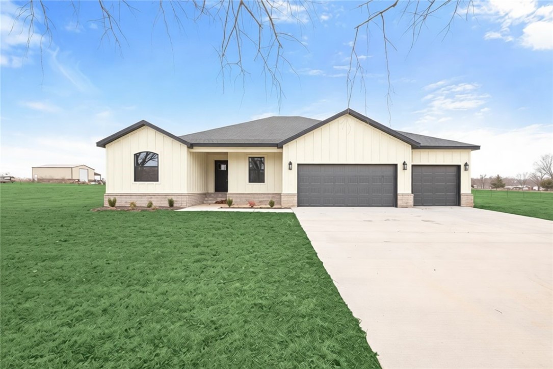 Amazing New Build on 1 Acre! $15,000 Buyer Concessions, use towards close costs, upgrades or rate buy down! 4 Bedroom home has gorgeous finishes throughout, including LVP flooring, Quartz counters, wainscoting & accent wall design. Living room boasts large windows & electric log fireplace. French doors lead to the media room, a great TV room or hang out space! Kitchen has gorgeous wood stained cabinets & white quartz counters. Enjoy counter seating space, electric range, built in wall oven & microwave. Dining space off kitchen has access to the covered patio. Primary suite has beautiful wood trimmed ceiling, large WIC & attached bath with soaking tub, large walk-in shower, & double vanity. Three guest bedrooms and a large guest bath offer great additional space. Laundry room w/extra storage. 3 Car Garage. Enjoy your 1 Acre lot and all the possibilities that come with it, add a shop, plan a garden & more. Located less 20 min to Downtown Bentonville/Walmart Campus!