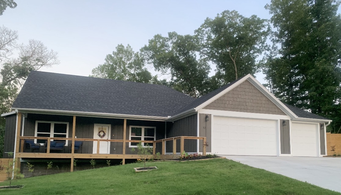 East side, Bentonville Schools, large (.40 acre) fenced corner lot and that hard to find 3 car garage home! Less than half a mile to trail access, 1.5 miles to Lake Ann access for your boat. 3.5 miles to the Metfield Recreation Complex for golf, fitness, swimming and pickleball.  A covered front porch welcomes you to this  home completed in September of 2025.  The living room with fireplace, vaulted ceiling with wood beam, flows into the designer inspired kitchen.  You have to see the kitchen island in person to appreciate the generous size and gorgeous quartz countertop along with the beautiful pendant lighting.   This dream kitchen has an abundance of cabinets and a large pantry. A split floor plan, with your primary suite featuring an oversized walk in closet with laundry access and a spa like bath.  Two additional bedrooms with walk in closets share the hall bath.  There is also an additional 1/2 bath as you access the garage. There is a large deck off the kitchen ready for your grill! Better than new!