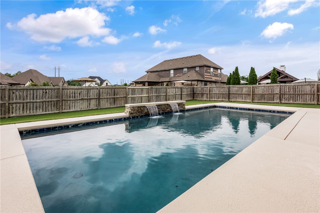 The home you've been waiting for! Step into luxury living with this stunning 5-bedroom, 3.5-bath home situated on a corner lot in one of NWA's most desirable locations. This home has an open-concept layout with a spacious living room and natural lighting. Kitchen features stainless steel appliances, granite countertops, cabinet storage, large laundry room. The main floor also has a formal dining room, a large primary suite with a beautiful bathroom and spacious walk-in closet, plus a bedroom and half bathroom. Head upstairs to find a massive bedroom with an en-suite bathroom and walk-in closet. Two bedrooms and bathroom. Don't miss the storm shelter! The backyard is a private retreat, complete with a heated gunite saltwater pool with a waterfall and cooling deck, perfect for hosting! Conveniently located just minutes from downtown Bentonville. Residents also enjoy the neighborhood amenities with a pool, playground, and basketball court. New roof 2025, pool 2021. Schedule your showing today. Welcome Home!