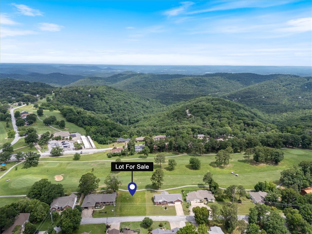 Ready, Set, BUILD!!! Looking to build your dream home near Table Rock Lake? Want property that is centrally located in NWA...this is it. Just minutes from the deep blue waters of Table Rock Lake and the Holiday Island Marina. Downtown Eureka Springs is a short 10 minutes away and boasts 5 star restaurants, colorful night life, art galleries, and several shopping centers. You will also be just about 45 minutes from Branson Missouri to the north and Bentonville to the west. Location is key. You can golf in the early morning, water ski in the afternoon and still make it to Branson for dinner and a show! This lot has already been cleared and is ready for your builder, no extra prep needed and public utilities are on site. This is a quiet side street with wonderful neighbors, but still so close to the country club that you can see it just across the fairway on the back side of the lot.