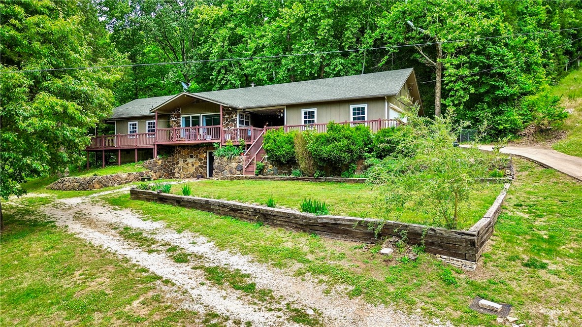Tucked into the Ozark Mountains just minutes from the legendary Buffalo River, this charming 4-bedroom home on 3.08 wooded acres in Marble Falls offers that kind of serenity that's getting harder to find these days. 3 comfortable bedrooms on the main level and a 4th in the walkout basement — perfect for a home office, workout space, or a bunk room after long days on the trail. Make your rural dreams come to life with the included 2,000sf barn equipped with water & electricity. To top it off, you're a stone's throw away from world-class float trips, hiking trails, and some of the most beautiful hardwood canopies the Ozarks has to offer. This home shines with character, and the owner has taken care to make it feel tidy and welcoming, but it is priced to reflect a few of its cosmetic needs — meaning the next owner gets to put their own stamp on it without paying a premium for someone else's finishes. If you've been looking for a place to slow down, breathe deep, and soak in your very own slice of peace — this is it.