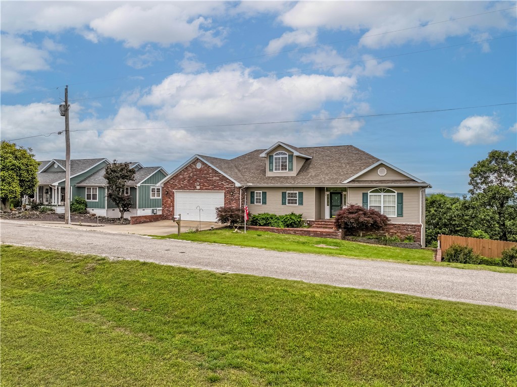 Stunning Home with Ozark Mountain Views – Across from Golf Course! The home offers breathtaking views of the Ozark Mountains from the rear decks & is ideally located directly across the street from the golf course. The home features 3 spacious bedrooms, 2.5 bathrooms, & a dedicated executive office, this property is designed for comfort and functionality. The main level features an attached 2-car garage, while the lower level includes a separate golf cart garage – perfect for enjoying the nearby greens. Just a short walk brings you to the main clubhouse. Community pools along with other amenities are only a quick drive away. There's also a full-service marina on Table Rock Lake with boat slip rentals available for your watercraft & for everyday convenience? Just across from the main entrance is a well-equipped shopping center featuring a grocery store, hardware store, restaurants, and more. This home truly has it all – views, location, amenities, and lifestyle. Schedule your private showing today before it's gone!