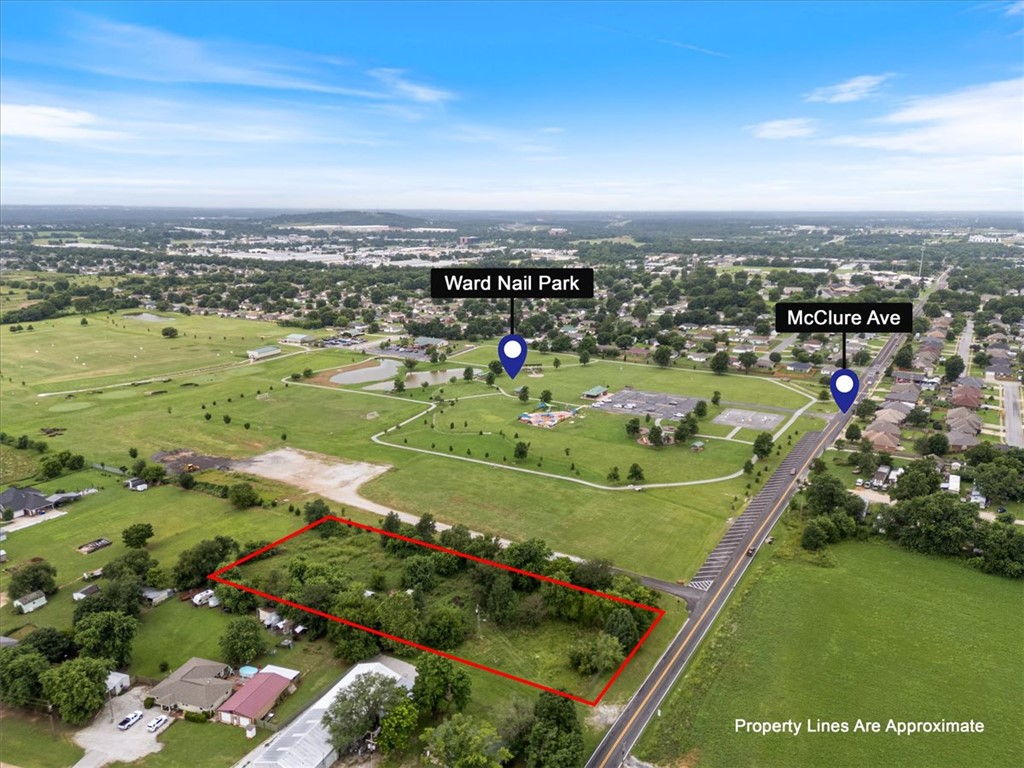 This 1.9 -acre C-2 Thoroughfare Commercial parcel in the heart of Lowell positions savvy buyers and visionary developers ahead of the curve in a market that is quite literally being built around it. Identified as one of NWA's hottest outlying submarkets, Lowell sits at the center of a region projected to double in population. With the future 412 Bypass and regional infrastructure investments underway, this property proves to be well-located commercial land. This property backs directly to Ward Nail Bark, the Mudtown BMX Park, and First Tee, offering exceptional visibility and a built-in connection to the surrounding residential community — a natural draw for retail, restaurant, service, or mixed-use concepts. C2 Zoning supports a wide range of development possibilities in a rapidly growing neighborhood where rooftops are multiplying and consumer demand is rising fast. An old well and septic system are present on the site; all available utilities and systems are to be independently verified by the buyer.