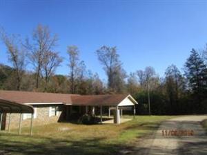 Regions only ''automatically'' pays prorated and back taxes (including liens and other clouds), realtor commissions, and a deed prep fee (up to $150). Located just outside of town, oversized lot, 2 carports, dog pen, outbuilding, partially wooded. New paint and carpet.