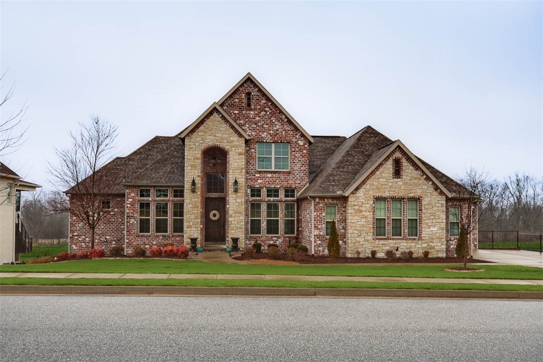 Homes of Distinction custom build! Backyard connects to the Razorback Greenway and features a brand new pool, pavilion, and outdoor kitchen! Amenities include a walkout basement, gated neighborhood, massive lot (.66 acres), 5 bedrooms (2 on main level), 3 full baths and 2 half baths (outdoor access to pool). Hand scraped wood floors, coffered ceilings, office, formal dining, gourmet kitchen, Kitchen Aid appliances, and a designer master bath with an oversized high end luxury walk-in closet. Flex room, tornado shelter, and a large downstairs rec room which is perfect for hosting and equipped with a large walk-in bar!  Kitchen refrigerator conveys.