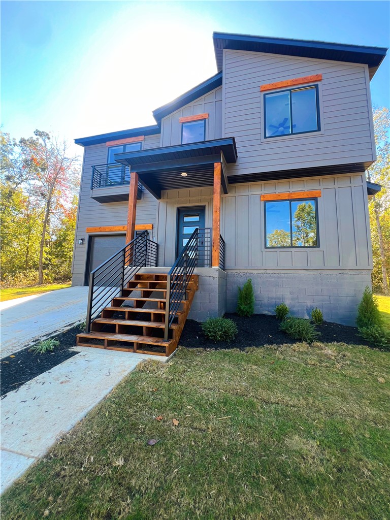 Beautiful new-construction home in Bella Vista featuring modern design, quality finishes, and a peaceful wooded setting. Built in 2025 this 3-bedroom, 2.5 bath home offers approximately 1,625 SF of thoughtfully designed living space on a 0.36- acre lot. The open-concept floor plan seamlessly connects the living and kitchen areas, creating an ideal space for everyday living and entertaining. The kitchen features modern cabinetry, quartz countertops, stainless steel appliances, and large windows that bring in abundant natural light. The spacious primary suite includes a walk-in closet and a stylish en-suite bath, while two additional bedrooms offer flexibility for guests, family, or home office. Enjoy the covered patio and large backyard overlooking wooded surroundings for added privacy. Attached garage includes a pre-wired 50-amp EV charging station. Conveniently located just 20 minutes from downtown Bentonville and Walmart Headquarters.