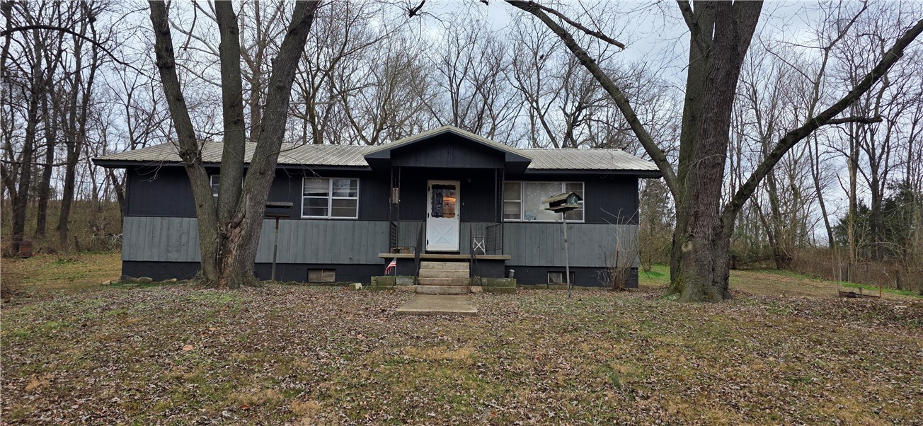Comfortable country living.  This home is sitting on a secluded 4.25 acres M/L with small natural spring fed stream running through it.  Home features 3 bedrooms, 11/2 bathrooms, with a nice sized living room and kitchen.  A full walkout basement provides ample storage/workshop area.  Home is close to beautiful Bull Shoals lake that has outstanding fishing and recreational activities.