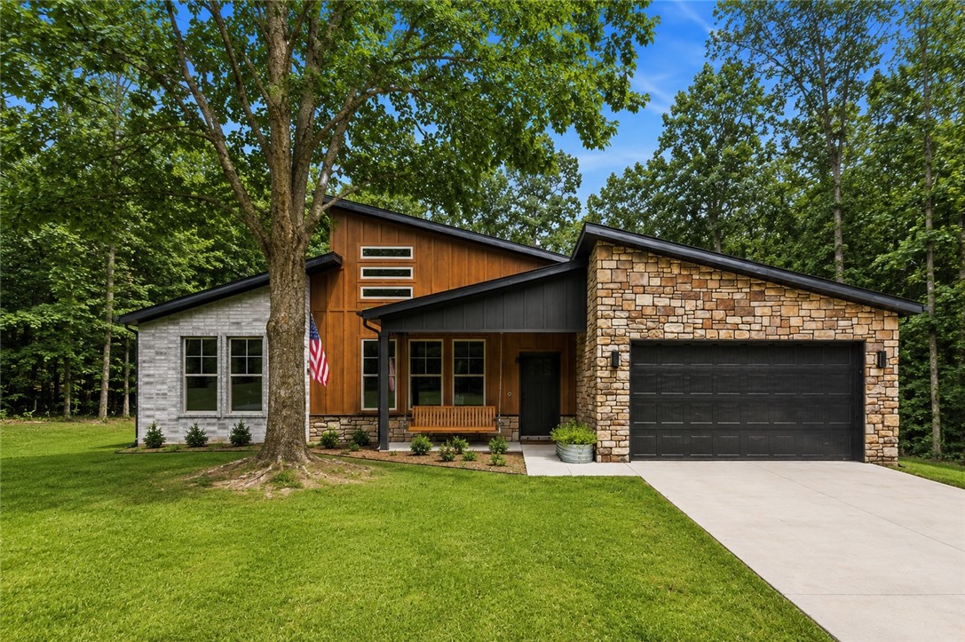 Welcome to this beautifully designed 3-bedroom, 2-bath home in the heart of Bella Vista! Offering a bright, open layout with a desirable split floor plan, this home combines modern finishes with everyday comfort. The spacious living room features soaring ceilings and abundant natural light, creating an inviting space to relax or entertain. The kitchen is equipped with custom cabinetry, granite countertops, and plenty of workspace for cooking and gathering. While the additional bedrooms provide flexibility for guests, family, or a home office. Outside, enjoy a large lot with a spacious back deck overlooking a fully fenced backyard perfect for entertaining, gardening, or simply enjoying the peaceful surroundings. Conveniently located near Bella Vista's renowned golf courses, trails, lakes, and parks, this home is ready for its next owner. Fridge conveys with house.