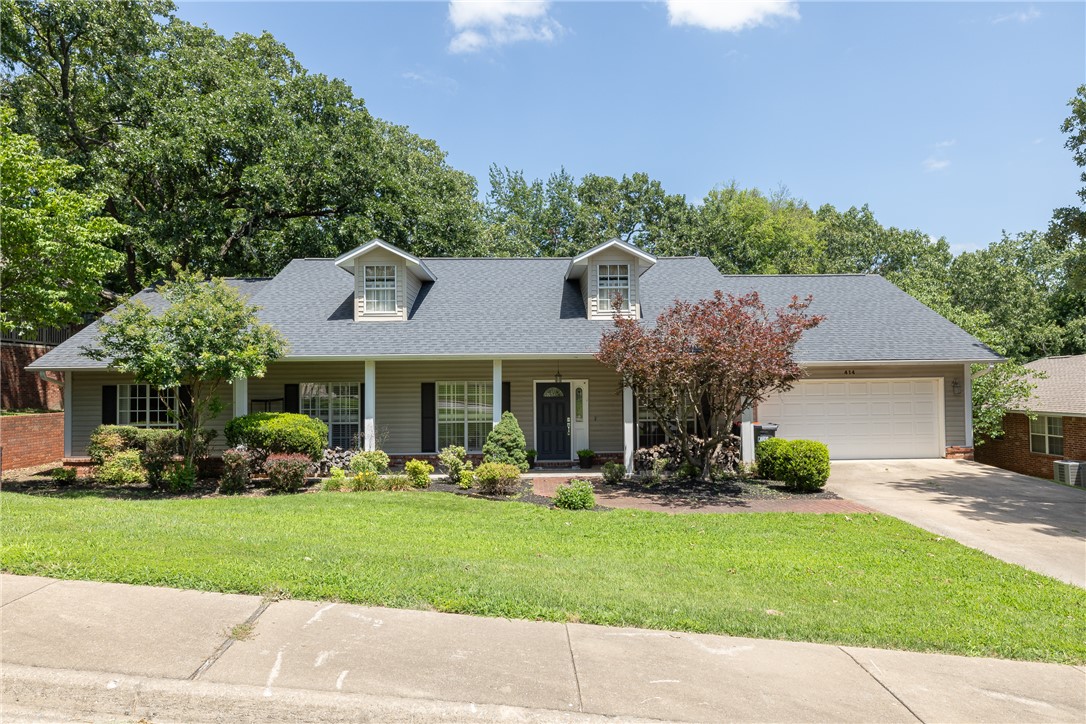Welcome to 414 Oak Manor Circle, Springdale, AR 72764! This beautifully maintained one-level home offers 3 bedrooms, 2 bathrooms, and spacious living areas designed for everyday living and entertaining.  Situated on a quiet circle with mature trees, you'll enjoy a seasonal view of Lake Fayetteville. Minutes from Springdale Country Club, Lake Fayetteville, Northwest Arkansas Mall, and the Razorback Greenway Trail System, this home offers comfort, convenience, and an unbeatable location. The kitchen features granite countertops, a gas range, ample cabinetry, and an eat-in dining area overlooking the backyard. Plantation shutters throughout add timeless style and charm.  The dedicated office includes custom built-ins and a built-in desk, creating the perfect work-from-home space with plenty of storage.  Retreat to the spacious primary suite featuring a bay window, dual closets, and an en-suite bath with a soaking tub and separate shower Much more, don't miss your chance to make it yours!