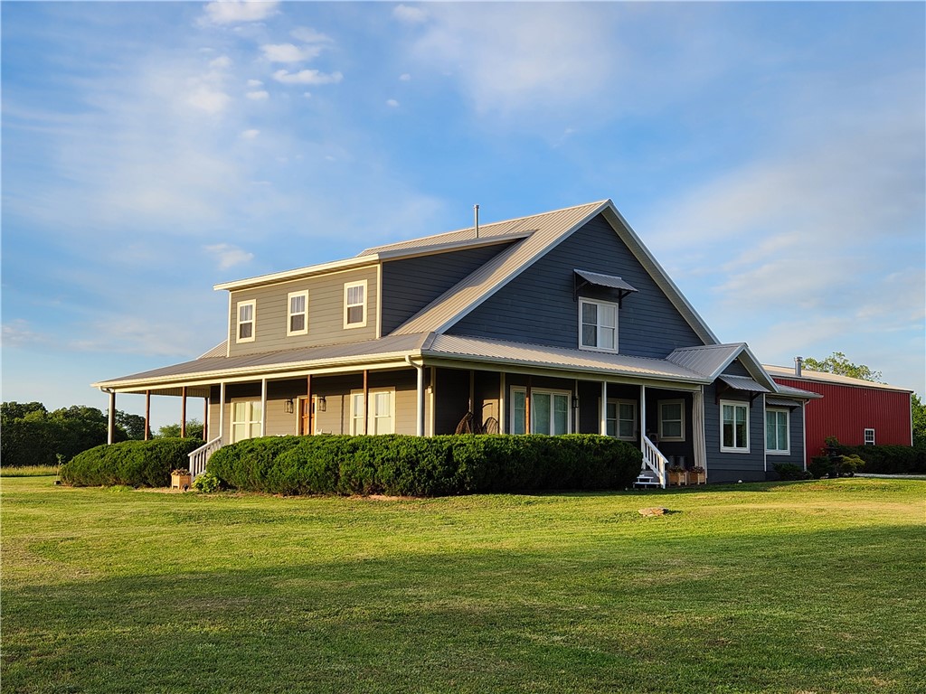 Tucked into the countryside of Gentry, this property offers space and privacy rare in NW Arkansas. Set on approximately 20 acres, it blends rural living with access to major employment centers, amenities, and XNA. The home spans 3,886 sqft with generous living spaces for everyday comfort and entertaining. Large windows bring in natural light and frame views of the surrounding pasture and mature trees. The land includes a pond, open acreage for recreation or animals, and multiple outbuildings that add flexibility. A large insulated shop with 50 amp/250 volt RV or generator capability provides ample room for projects, storage, or equipment, while the classic barn adds character and functional agricultural or hobby space. Additional highlights include a central vacuum system, tankless water heater, a pantry that doubles as a structural safe room and tornado shelter, a fully owned 500-gallon propane tank, and a pool-ready backyard. Ideal for a private homestead, hobby farm, or enjoying NWA.