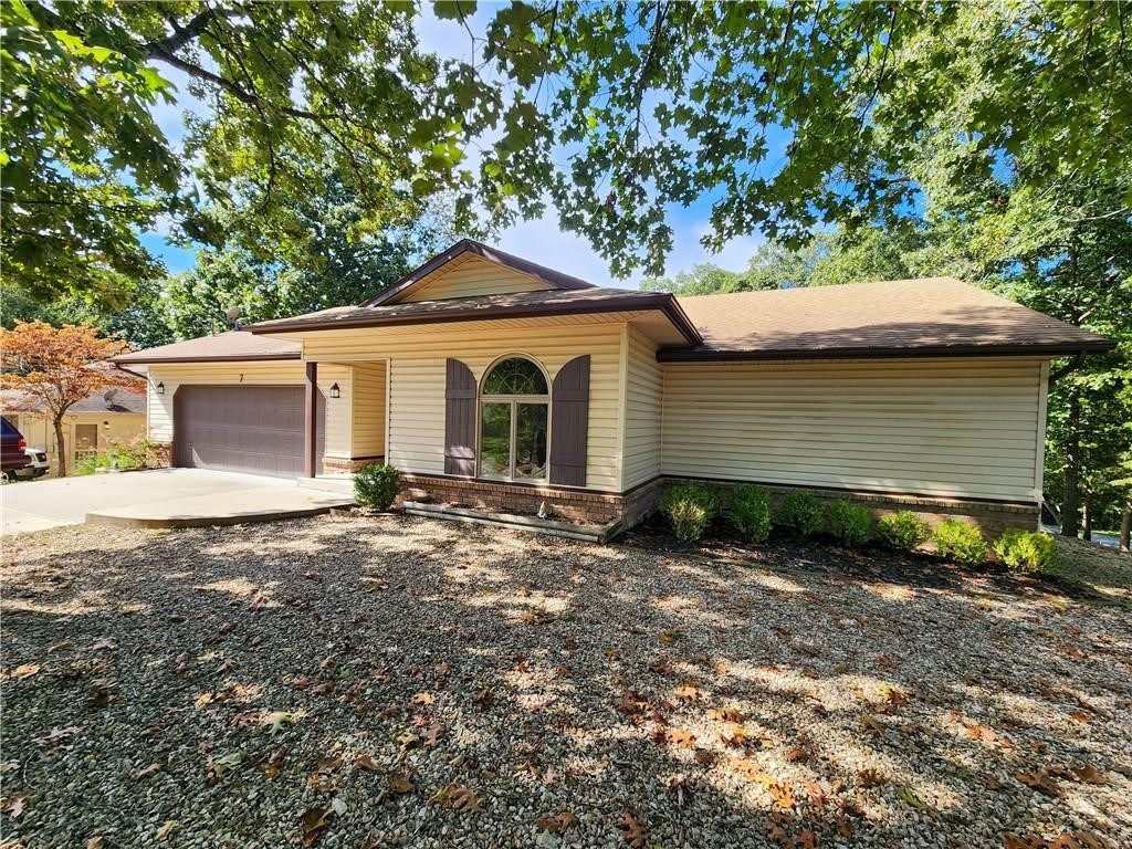 Fantastic Bella Vista corner lot home with an open split floor plan. This home features a large living room with vaulted ceilings, wood accents, and skylights. The living room has a pellet stove fireplace. The walk out basement features a living room as well as unfinished storage area or workshop. Enjoy the back yard with privacy fence and newly stained deck with pergola. Maintenance free exterior. Many updates completed in 2019 including, HVAC, roof, flooring, fixtures, carpet, toilets, deck and neutral paint throughout. Enjoy all that Bella Vista has to offer.