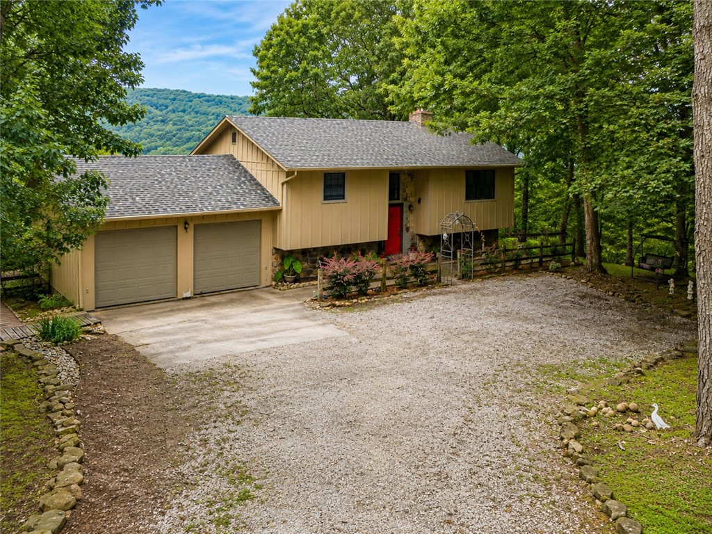 Location, Location, Location! Million-dollar mountaintop views from every window! Beautiful, well-maintained 2+ bedroom (easily converted to 3), 2-bath split-level home  2 car garage, with an office/second living area, bonus/flex room, fireplaces, walkout basement, workshop, and detached shed. Multiple outdoor living spaces showcase the breathtaking views. Enjoy peaceful country living on a paved road at the end of a quiet street, just minutes from downtown Eureka Springs, Berryville Walmart, TJ Maxx, Tractor Supply, restaurants, and the King's River! Recent updates include newly finished peg wood hardwood  flooring, fresh interior and exterior paint, updated lighting, granite with remodel, updated bathrooms, new patio doors to a screened porch, a 3-section deck (2025), roof (2023), Leaf Filter gutters, frost free spigots and a fenced backyard; perfect for pets!  One of Eureka's hidden gems nestled  in the Ozarks! Tranquility & Convenience Lives here, You Could too?See this ONE today before it disappears.