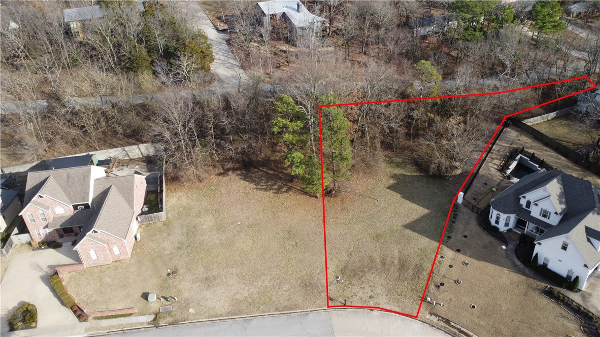 Build your dream home in this quiet neighborhood, while being right in the heart of Fayetteville! Watch the sunset over the tree-covered hills right from your front door! This building lot is located just off Mission Blvd in East Fayetteville at the base of Mt Sequoyah, near Root Elementary, shopping, parks, and trails. The new home must be a minimum of 2400 sf. Lot fronts 3 streets, possible entrance from rear.