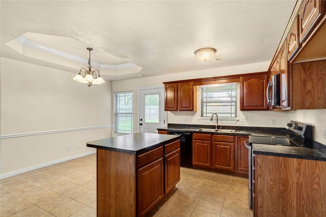 Charming English cottage in Stonecrest Addition. Homes in this adorable addition are hard to come by. Don't miss out on this one with wood floors in split open plan, lovely large fenced yard. Well taken care of.