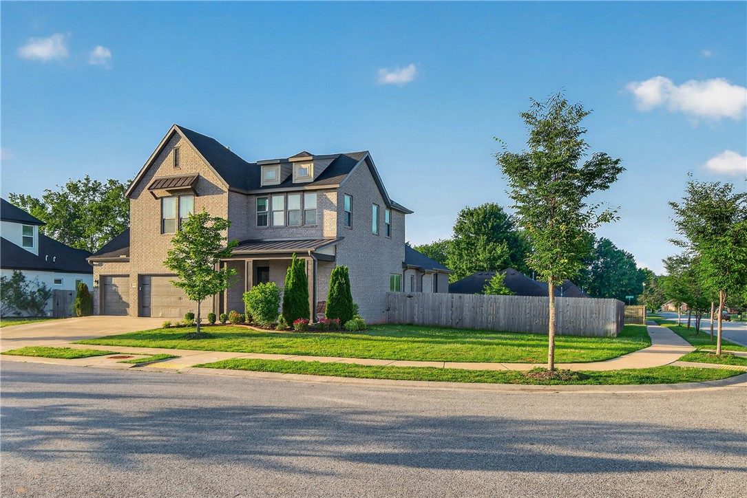 **Buyer may receive up to 1.5% of the purchase price toward closing costs/lender allowables when using preferred lender, with acceptable offer and loan qualification. Seller is also offering a $3,000 flooring/cosmetic allowance with acceptable offer.** Stunning one-owner home in sought-after Magnolia Park on a .29-acre corner lot. This beautifully upgraded 5-bed, 3.5-bath West Fayetteville home blends modern style with everyday comfort. Bright, open-concept kitchen, dining, and living areas are filled with natural light and perfect for entertaining. The main-level primary suite features an expanded layout and spacious walk-in closet. Upstairs offers flexible space for a playroom, office, or second living area. A true 3-car garage with 7-ft doors and 220 outlets is ideal for EV charging, hobbies, or projects. Enjoy the covered enclosed patio with fireplace and TV for year-round outdoor living. Walk to schools and trails, with easy access to major NWA employers and the University of Arkansas.