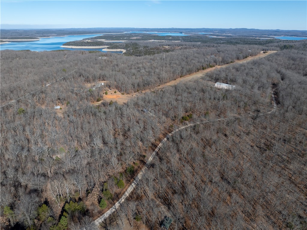 Discover a combined 10.54 wooded acres in the sought-after Webb’s Landing 3 Subdivision near Bull Shoals Lake, offering a peaceful Ozark setting with potential lake views, excellent recreational access, & exceptional privacy. One parcel includes a Derksen shed hunting cabin with heating & cooling & a propane stovetop, making it a convenient base camp (no water or septic in place). The adjoining acreage borders Corps of Engineers land on Bull Shoals Lake, providing protected surroundings & no future development behind you.

Enjoy quick access to Bull Shoals Lake for fishing, boating, & recreation, plus a nearby public boat launch. Aviation enthusiasts will appreciate proximity to Pine Mountain Air Park (6AR9). With light restrictions, this combined offering is ideal for a dream home, lake retreat, or getaway, located about one hour from Branson, Missouri.