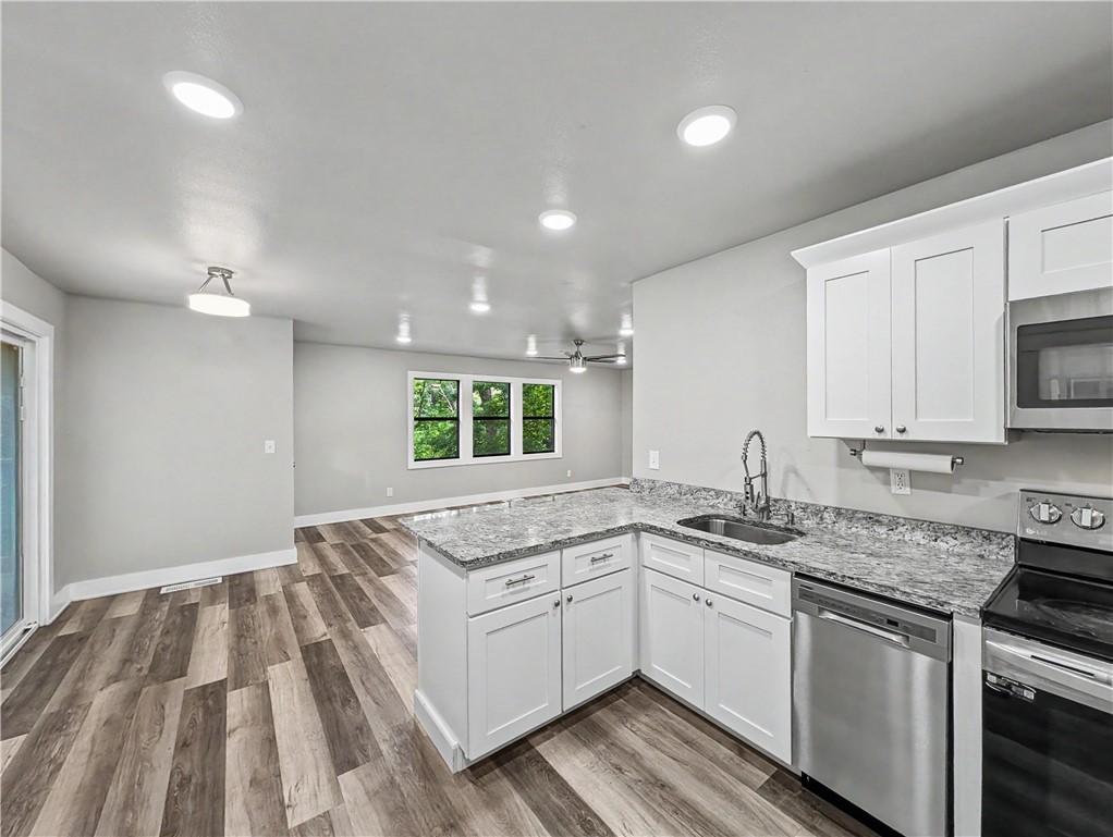 Welcome to  your next home in this beautifully remodeled 2-bedroom, 2-bathroom rental located on the highly desirable east side of Bella Vista. This charming property features durable, modern luxury vinyl plank flooring throughout and a fully updated kitchen equipped with all appliances, including a refrigerator and a stacked washer and dryer for ultimate move-in convenience.  Step outside to relax on the spacious deck, perfect for taking in the stunning natural beauty of the area, or utilize the included carport and small storage building for extra convenience. Offering the perfect blend of comfort, style, and a prime location near all Bella Vista amenities, this home is ready for you to move right in.