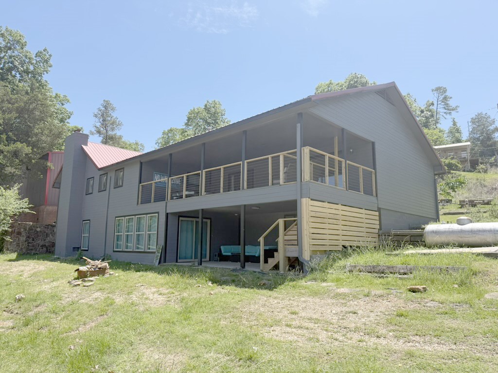 Lake Front!!! Turnkey House - Sold furnished with everything needed to rent as a short term rental or move right in. Amazing view overlooking Rocky Branch Marina. Large deck perfect for entertaining. Over 1/2 acre on the water. 1500 sf. detached shop. 109 ft of Shoreline, new water heater, new AC unit, remolded downstairs with new window and door.  This home can sleep 15 people in beds. King Bed-Master / twin over queen- room off of master for kids /  King Bed - Second Bedroom with its own full bath. Bunk room - 2 Queen bunk beds. Garage could be closed in to make additional SF.  The Lot could be split to build another home. Many opportunities with this home.