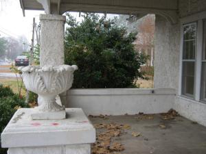 ROMANTIC WANTED--who will truly appreciate the high ceilings,  intricate detailing, numerous windows! Beautiful, Mediterranean style home offers spacious rooms & large baths! Newer gas CHA, new showers/tub in baths. Huge lawn with little red barn plus detached garage. Storm cellar under house for shelter.