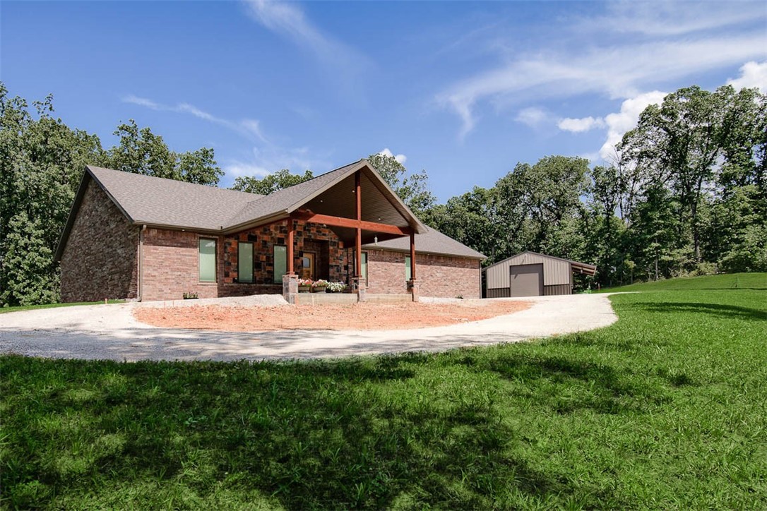 Gorgeous custom 2266 sq ft brick home&2nd home of 1218 sq ft barndo/shop/AirB&B on 5 acres of beauty in the best location in NWA near bike trails & lift. Luxurious attention to every detail for quality, functionality & efficiency. Grand entrance w/custom alder wood door opens to breathtaking knotty pine ceilings throughout, abundant knotty alder cabinetry, magnificent main bedroom suite w/massive closets, dreamy spa like main bath w/heated flooring & towel warmers. Coveted laundry rm/storage. Stunning granite countertops throughout including floor to ceiling backsplash. Black ice, top of the line Kitchen Aid appliances including fridge, W/D, gas cook top, ducted hood. Gorgeous tiled flooring. H&A attic storage space. H&A pristine oversized 2 car garage/workshop space. Office space, storm room, glorious private back yard overlooking nature. Energy efficient in every way (Electric runs $24.00/mo for both homes. The best Pella exterior doors & windows. Dual Heat system. Barndo has full kitchen, full bath, fridge, W/D.