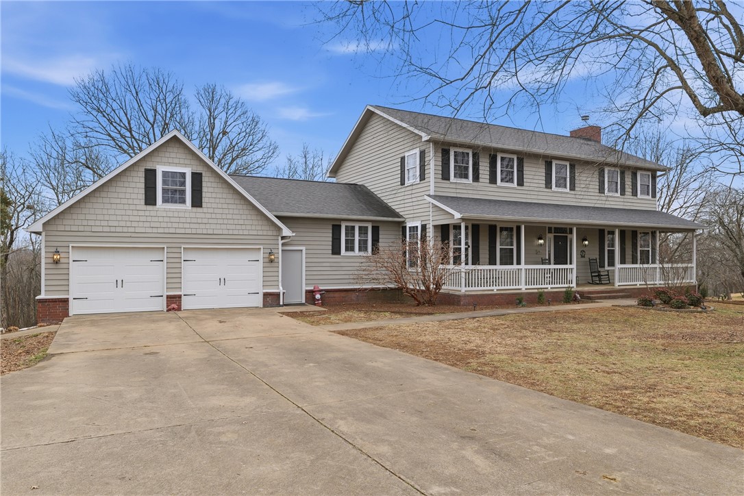 Updated 6BR/4BA home on a 1.57-acre lot in an East Fayetteville neighborhood offering privacy, space, & close-to-town convenience. A welcoming large front porch and spacious back deck create ideal spaces for family time & entertaining. The main floor features refinished hardwood floors extended into the kitchen and renovated with a new island & countertops - perfect for gatherings and everyday living - as well as soft close hinges & farmhouse sink. Flexible main-level spaces include a flex room with 360 degree, floor-to-ceiling built-in bookshelves & a wide, sunken family room with fireplace & abundant natural light. Upstairs, the primary suite offers a peaceful retreat with an updated en suite bath featuring a remodeled shower & flooring. The finished basement provides a true mother-in-law suite with full kitchen, living room, two bedrooms, & full bath—ideal for extended family or guests. An extended driveway allows easy rear access. A rare opportunity to enjoy room to grow in a private, established setting.