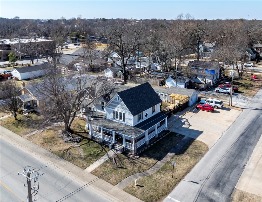 A rare opportunity in the heart of Siloam Springs! This meticulously maintained 1907 historic home offers exceptional live/work and income-producing potential. The main level currently operates as a chiropractic office featuring ADA accessibility, three private office spaces, half bath, and existing three-phase power—ideal for medical or professional use. New roof and new windows upstairs in main house. The upstairs living quarters include a kitchen, bedroom, full bath, and an additional bedroom on the third floor.

Also included is a detached cottage home built in 2001, operating as an active short term rental, or in-law suite, offering two separate 500 sq ft levels, each with a one-bedroom, one-bath layout and kitchen. Enjoy custom decks, a detached garage/workshop, carport, street parking for clients, and a landscaped backyard with raised garden beds. Located across from a park, farmers market, and library and just minutes from downtown. Also listed as commercial MLS 1345479