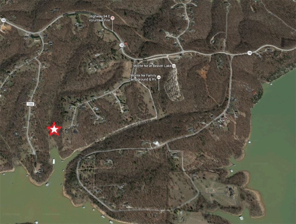 Affordable and close to town, this lakefront lot offers some privacy and lake access with over 192ft of shoreline. Build a vacation getaway or your homestay, either way you will love the peace and quiet and privacy yet with city amenities close by. Not many lakefront lots are this easy to build on, level building site and underground utilities at street, storage building conveys. Only 5 minutes from downtown Rogers and minutes to Marina by land or by water, don't wait come start living the lake life.