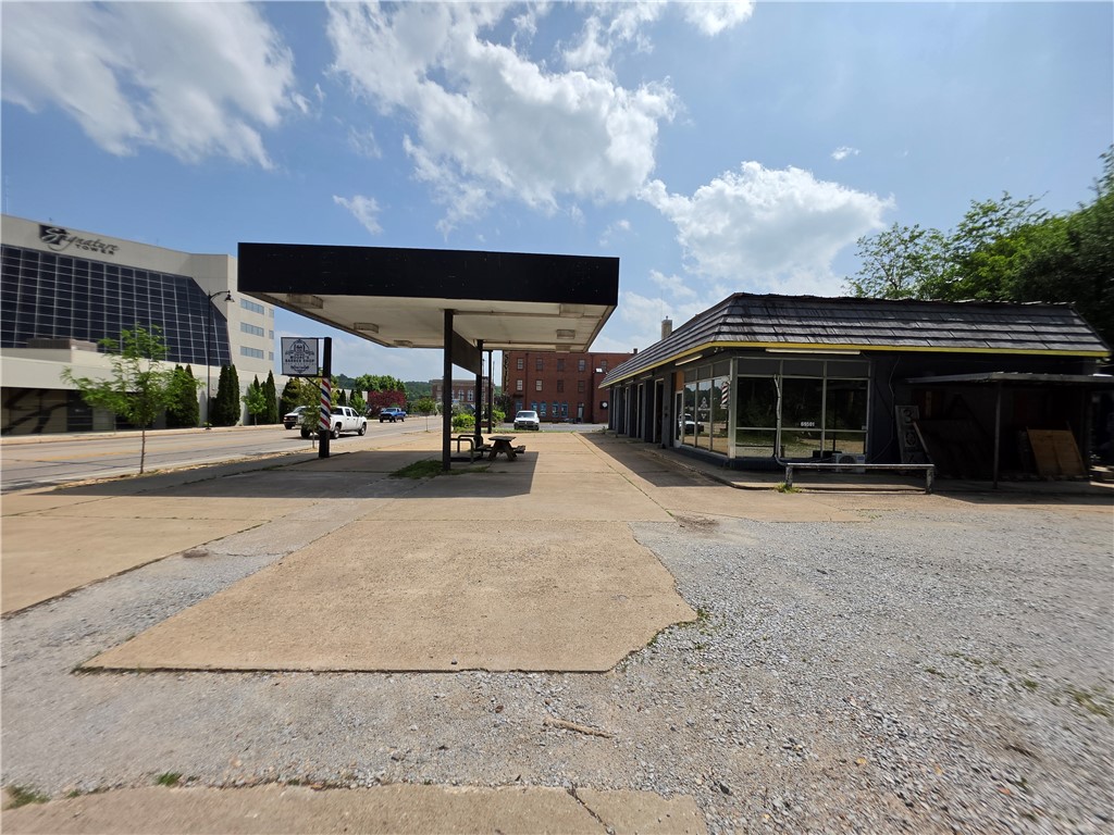 Anchoring the north edge of Harrison's emerging entertainment district, 306 N. Main offers a rare combination of presence, position, and income. Set on 0.41 acres with direct Main Street frontage — and just one block off the historic Harrison Square — this 3,572-square-foot commercial building puts an owner-operator or investor at the literal center of Harrison's most active corridor.  

Zoned C-3 Commercial, the property accommodates a wide range of uses, from retail and service businesses to hospitality, food and beverage, professional offices, or mixed-use redevelopment. A long-term barbershop tenant currently occupies the front of the building, generating immediate rental income while leaving substantial flexibility for an incoming owner's vision.

The location speaks for itself: walkable to the Square, embedded in the entertainment district that is reshaping downtown Harrison, and benefiting from the foot traffic and visibility that only true Main Street frontage can provide.