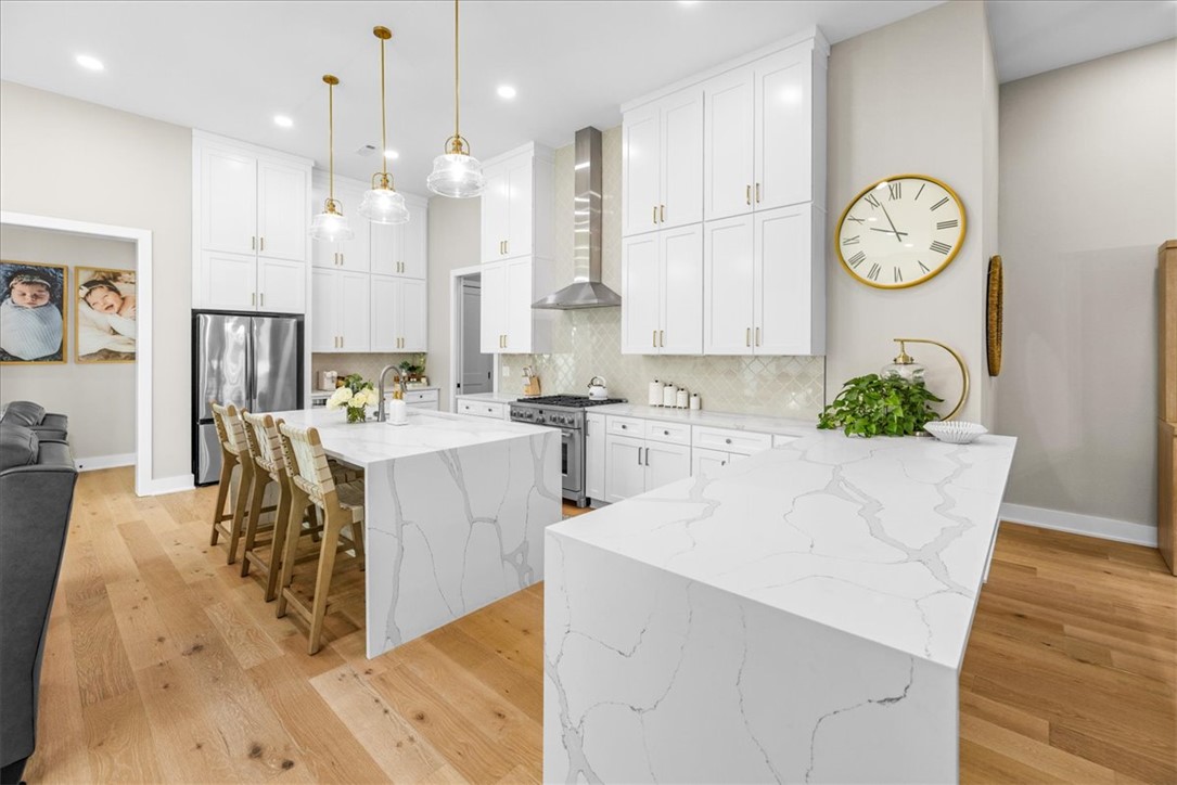 Tucked in the desirable Harmony neighborhood within the Aurora community, this 2,163 sq ft garden home offers 2 bedrooms and 2.5 baths with a well-designed, open layout. Natural light fills the living spaces, highlighting clean lines and thoughtful details throughout. The kitchen features quartz countertops, a striking waterfall island, and abundant storage—perfect for both everyday living and entertaining. The spacious primary suite offers a true retreat, complete with a luxurious, spa-like bath and an oversized walk-in closet. Enjoy low-maintenance living with HOA-covered internet, lawn care, and courtyard maintenance. Community amenities include two pools, clubhouse, playground, dog park, bike repair station, fitness course, and basketball/pickleball court. Convenient Bentonville location with easy access to I-49, shopping, and dining.