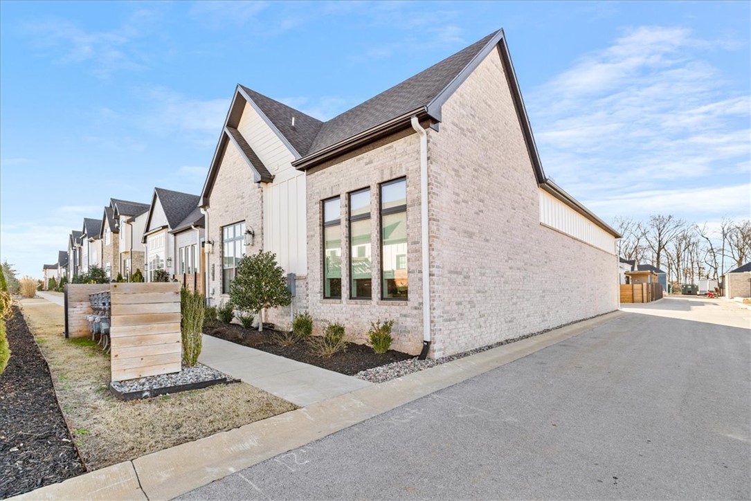 Tucked in the desirable Harmony neighborhood within the Aurora community, this 2,163 sq ft garden home offers 2 bedrooms and 2.5 baths with a well-designed, open layout. Natural light fills the living spaces, highlighting clean lines and thoughtful details throughout. The kitchen features quartz countertops, a striking waterfall island, and abundant storage—perfect for both everyday living and entertaining. The spacious primary suite offers a true retreat, complete with a luxurious, spa-like bath and an oversized walk-in closet. Enjoy low-maintenance living with HOA-covered internet, lawn care, and courtyard maintenance. Community amenities include two pools, clubhouse, playground, dog park, bike repair station, fitness course, and basketball/pickleball court. Convenient Bentonville location with easy access to I-49, shopping, and dining.