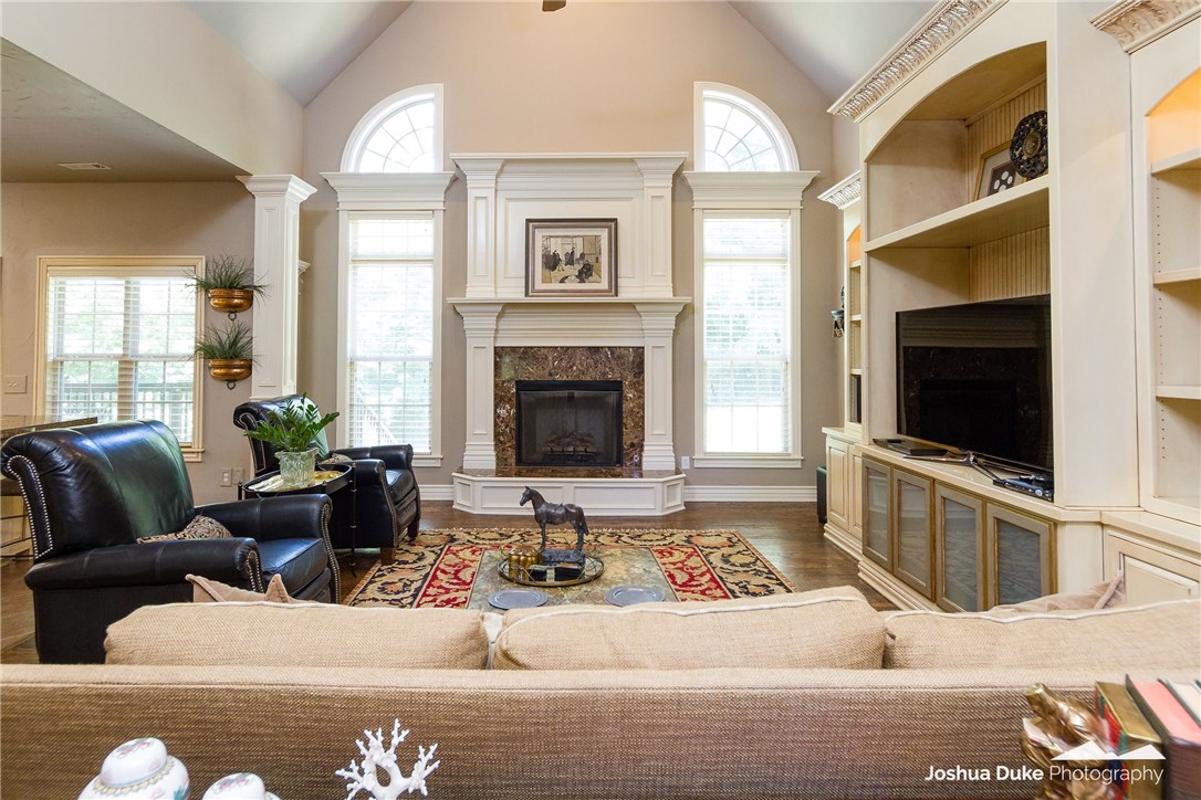 Custom Home in East Fayetteville!  4 Bedrooms/3 Full Baths.  Master downstairs with whirlpool tub, separate oversized shower, double vanity with custom cabinets, walk-in closet with built-ins.  Large kitchen with beautiful custom cabinets open to spacious living room and dining room.  Wonderful built-ins, vaulted ceiling, and gas fireplace in the living room.  Office on main floor.  2 bedrooms, 1 full bath with double vanity, and bonus room upstairs.  Bonus room features built-ins, mini fridge, bar sink, under cabinet lighting, wine holder with cabinets, granite countertops, and surround sound. All brick and stone exterior, covered patio with private, fenced backyard.  Sprinkler system.  Tankless water heater replaced in 2017.  Root, Woodland, and FHS Schools.  This one owner home is a must see!